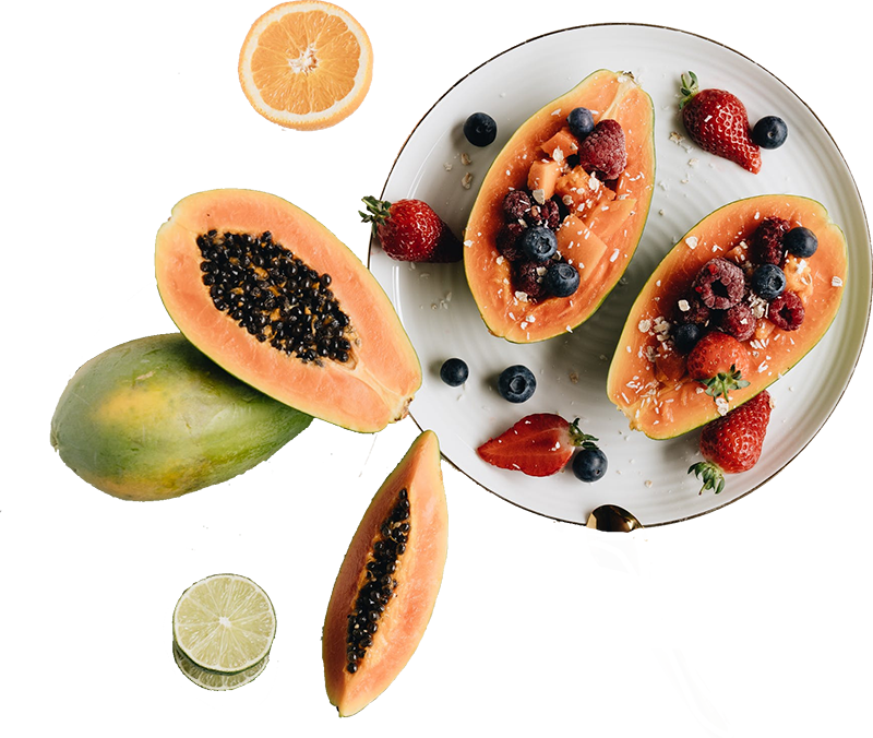papayas stuffed with berries on a white plate
